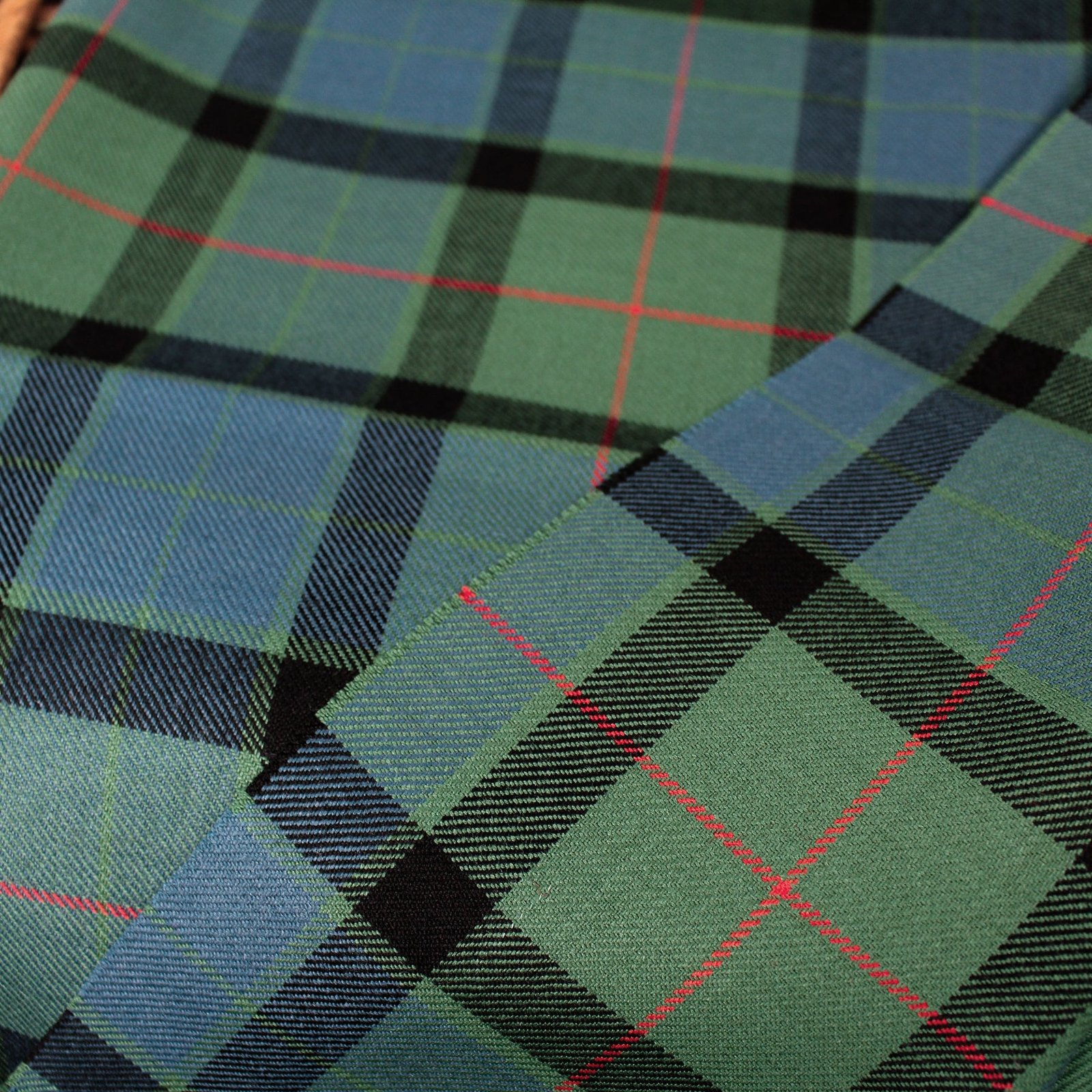 Premium green and blue yarn dyed fabric with red intersecting stripes