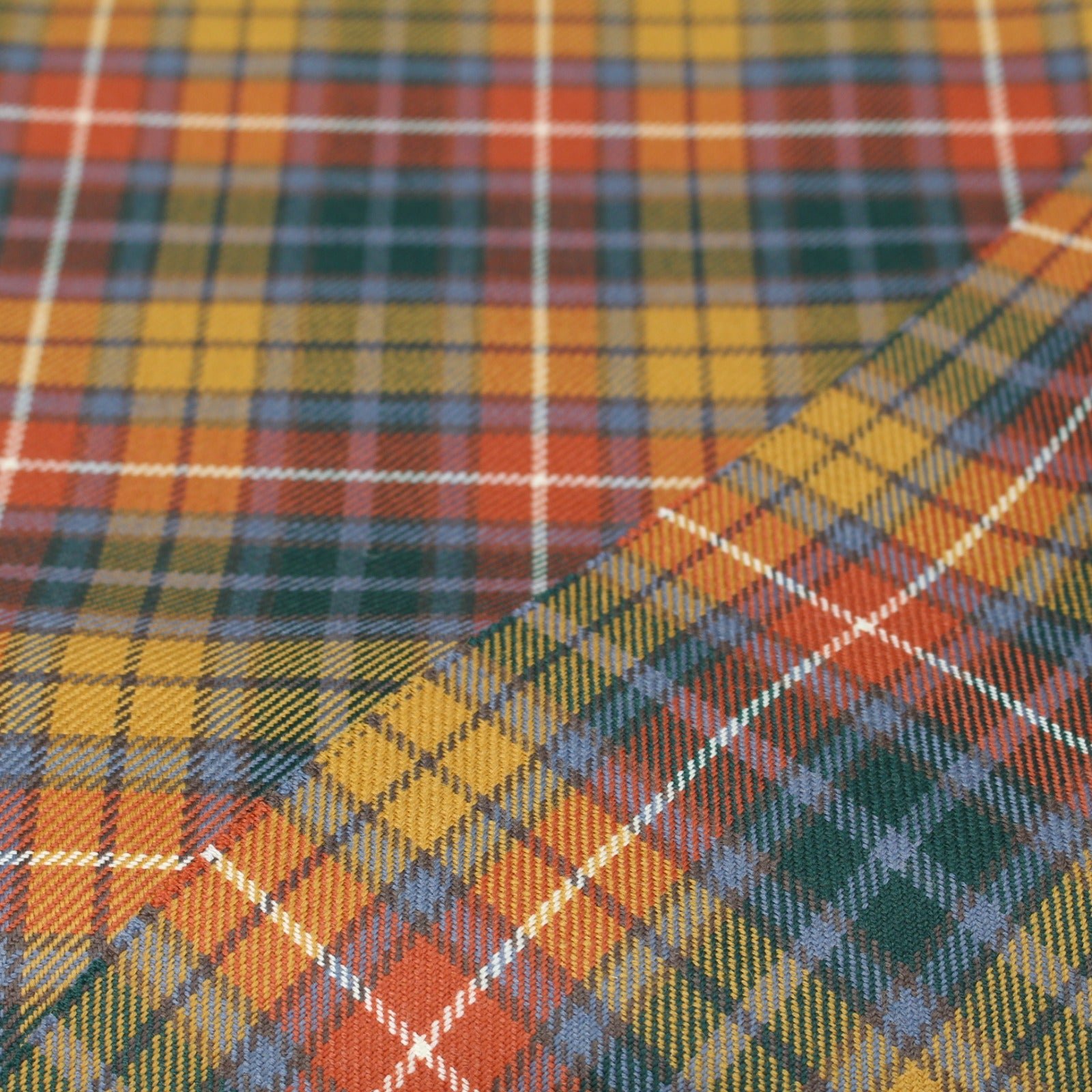 100% cotton Buchanan Tartan fabric in yellow, orange, and green, exported from Multan, Pakistan.