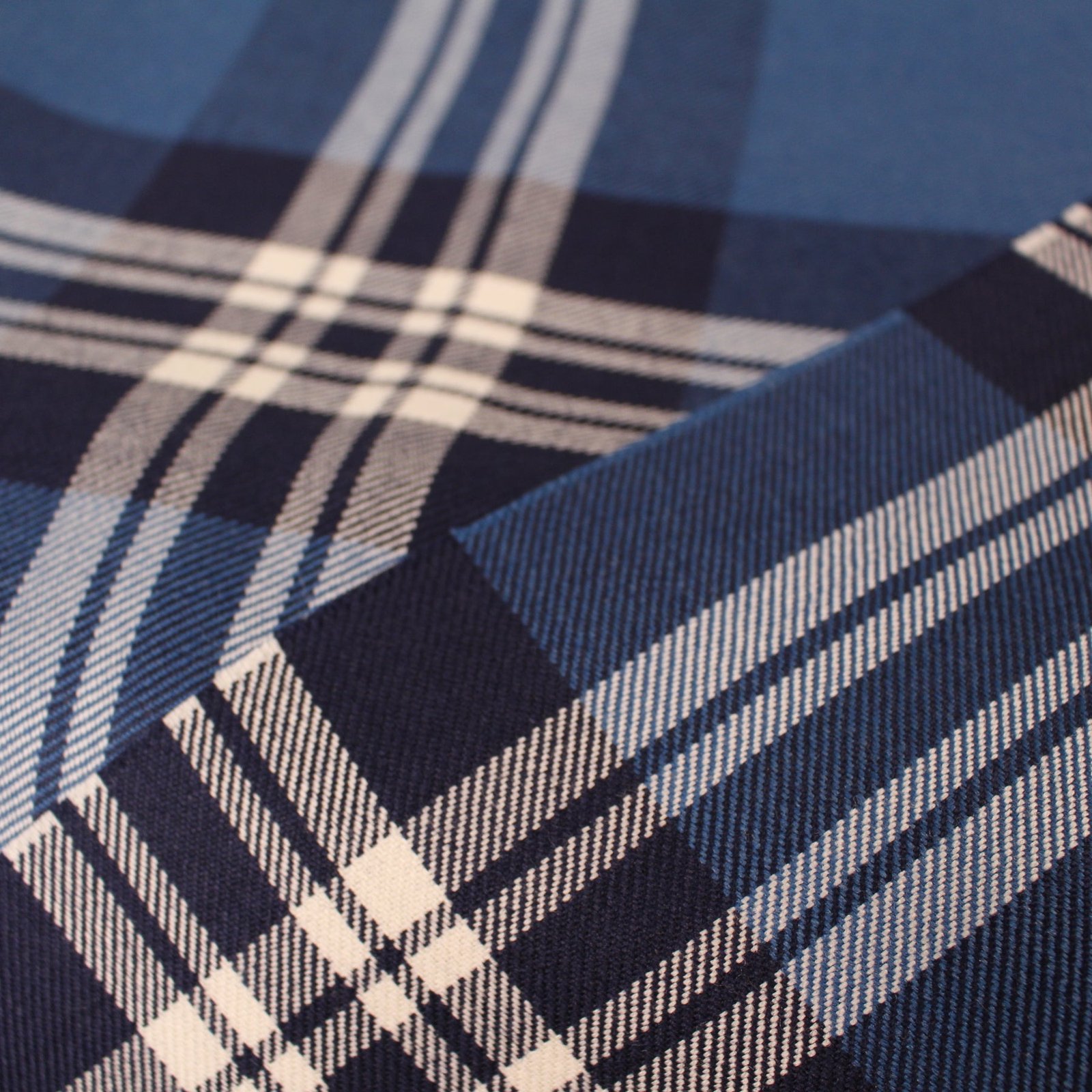 Premium navy and cream plaid flannel fabric with blue and white accents